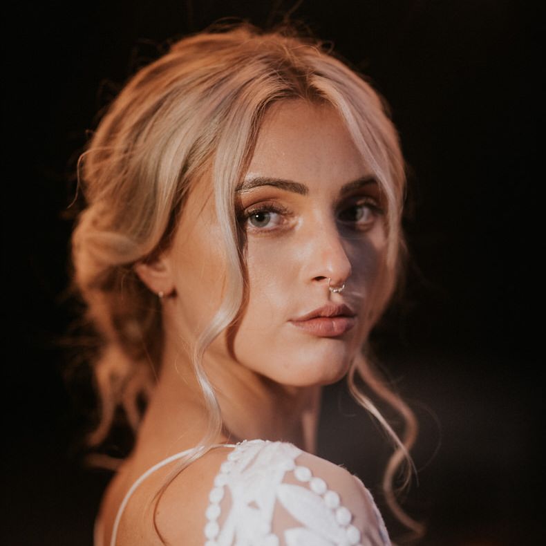 Bride wears her hair in an elegant relaxed updo