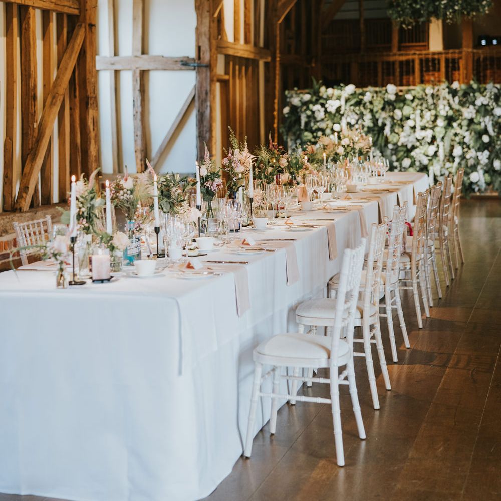 Wedding venue table decor featuring large floral bouquets 