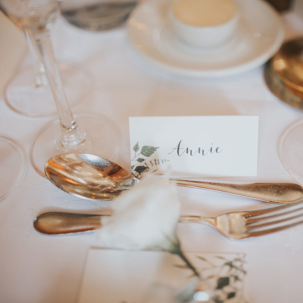 A white place card reads 'Annie' at Crab & Lobster fairytale wedding.