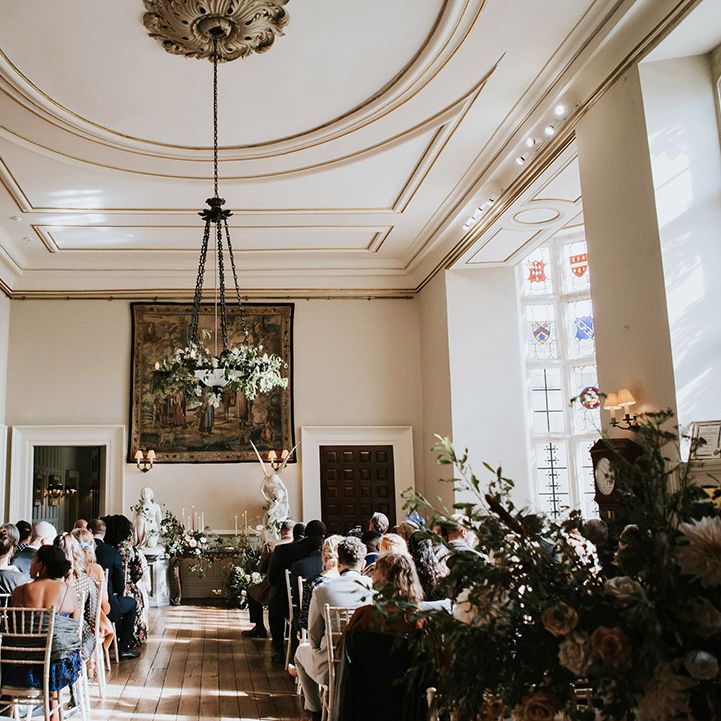 Elmore Court wedding ceremony room with romantic white, pink and green foliage floral arrangements 