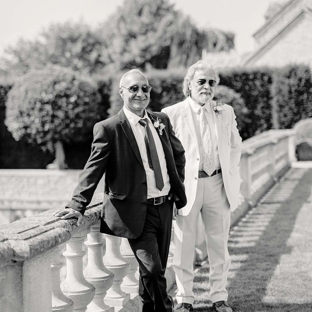 Black & white image of wedding part stood outside on wedding day at Euridge Manor 