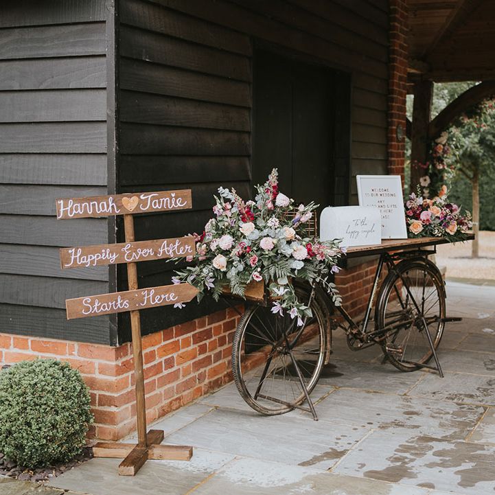 Handmade wooden sign with personalised details as well as an old bike with an area for the guest book 