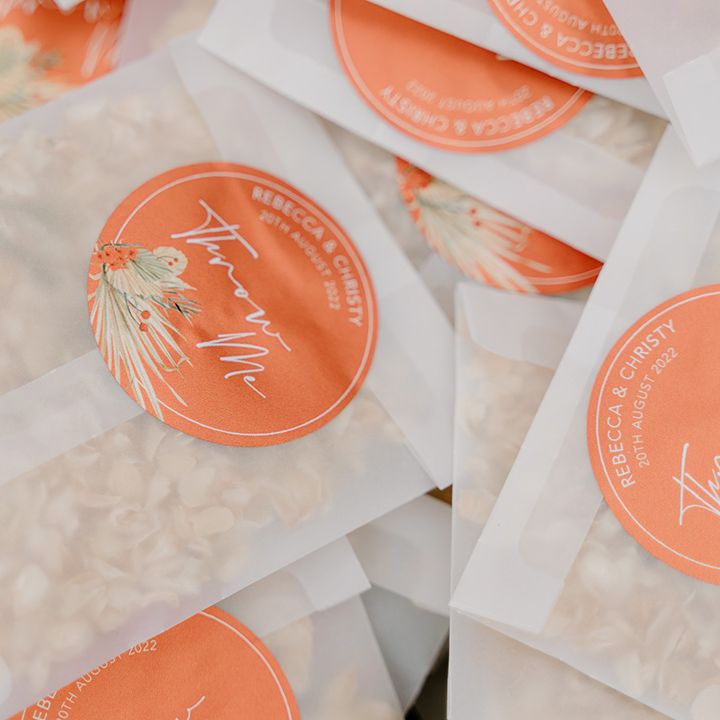 Pouches of confetti with a personalised orange sticker 