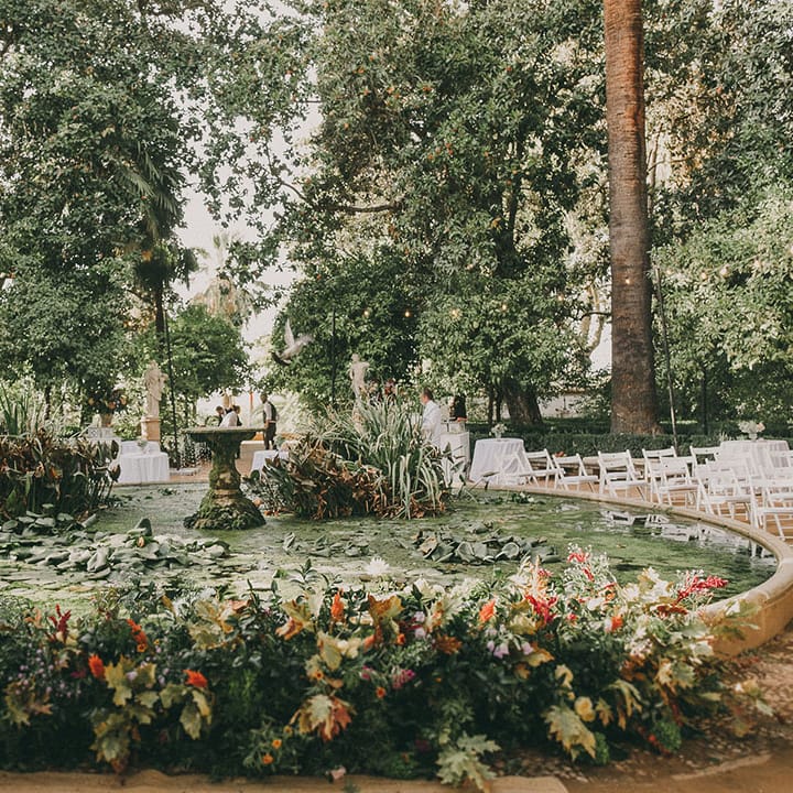 outdoor wedding ceremony by a fountain at Carmen de los Mártires wedding venue in spain