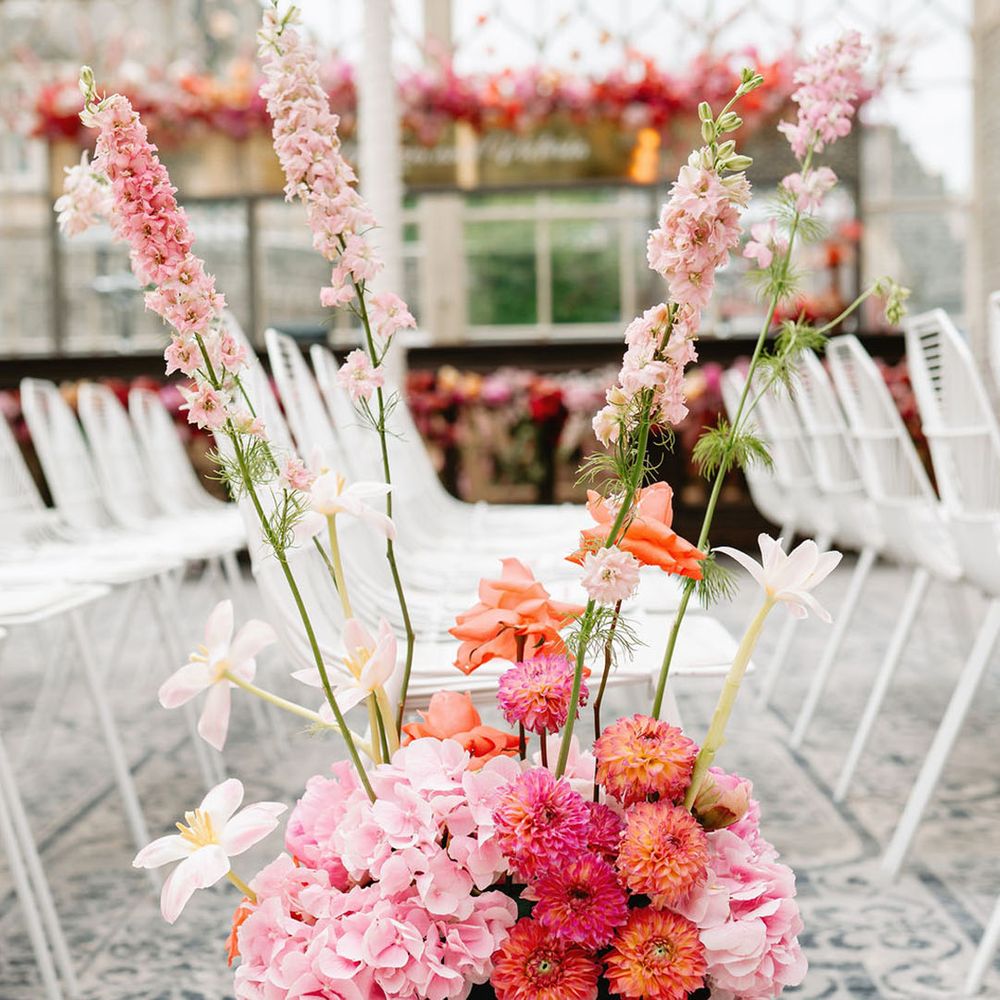 Hydrangeas, reflexed tulips, dahlias and more make up the colourful pink aisle flower decorations 