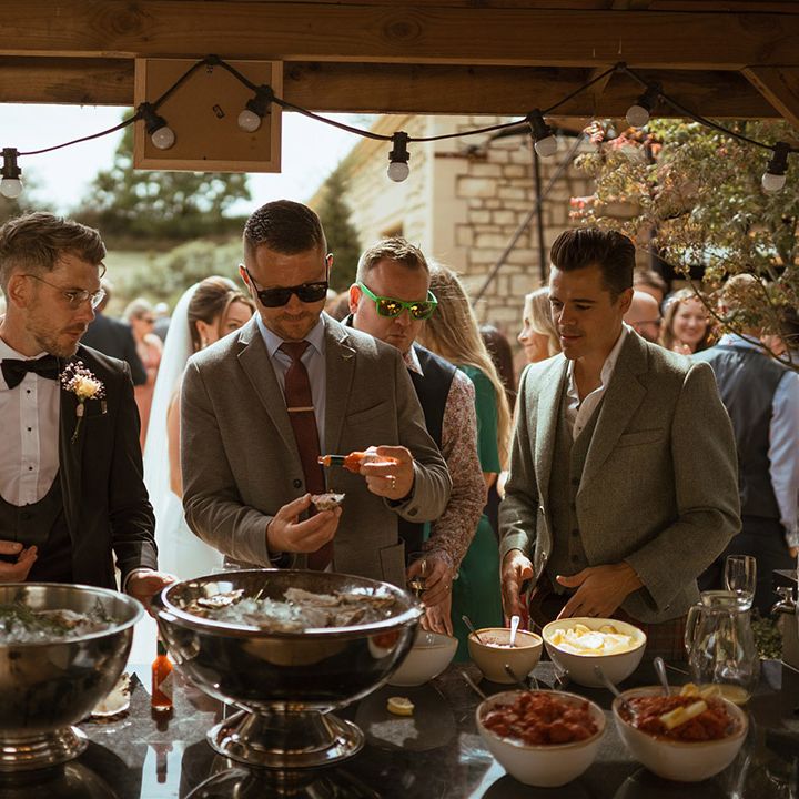 Wedding guests eat oysters for wedding food 