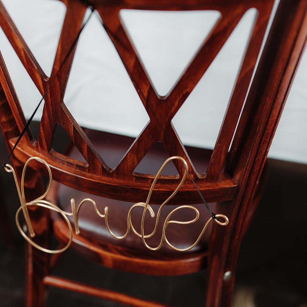Gold wire chair decoration to reserve the seat for the bride 