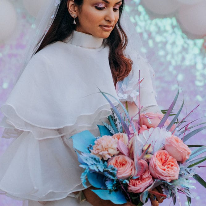 Bride holding her holographic pastel wedding bouquet 