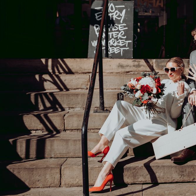 Stylish bride and groom showing off their wedding rings after their intimate micro wedding 