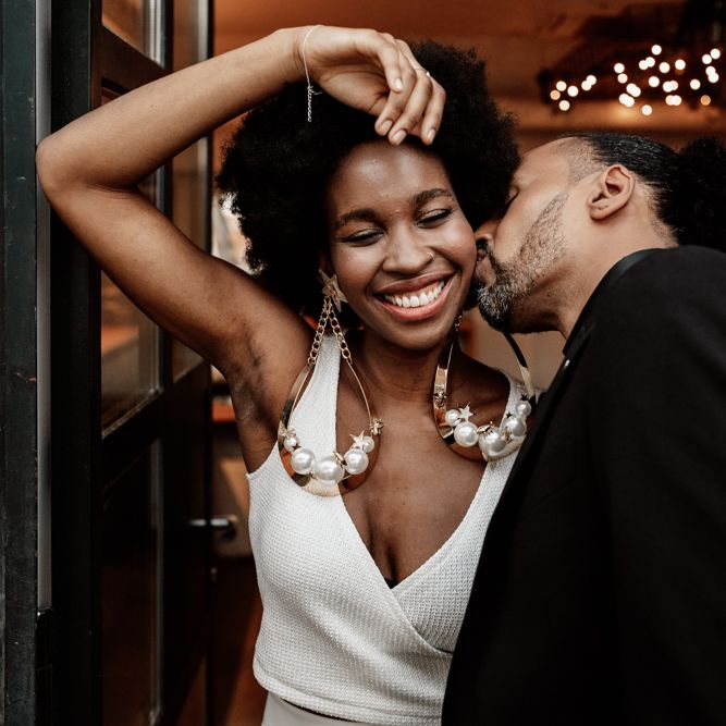 Groom kisses bride on wedding day 