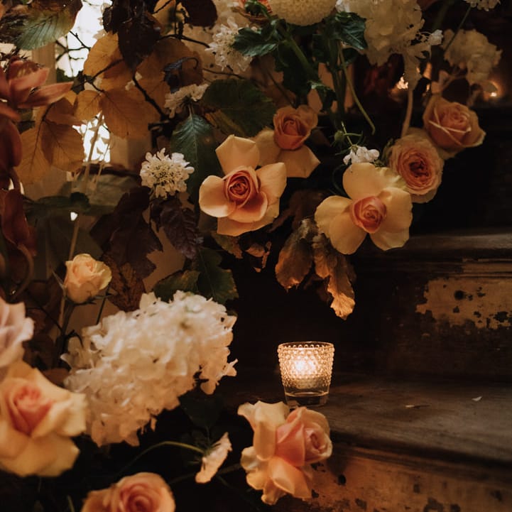 Floral candle display for autumn wedding at Reymerston Hall