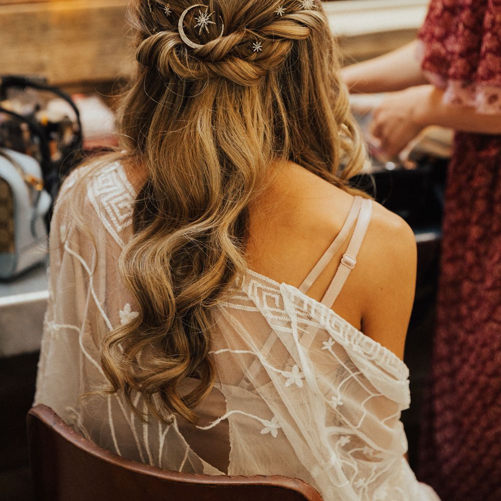 Curled long bridal hair style with celestial hair pins