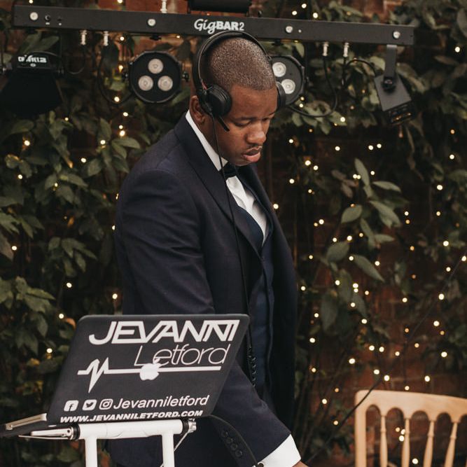 DJ standing at his decks 