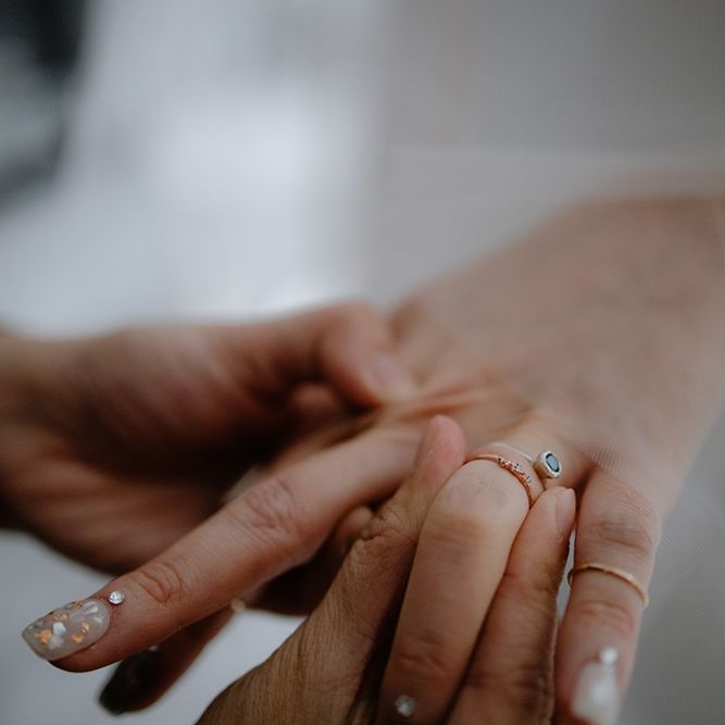 Stylish bridal nail art and delicate wedding rings 