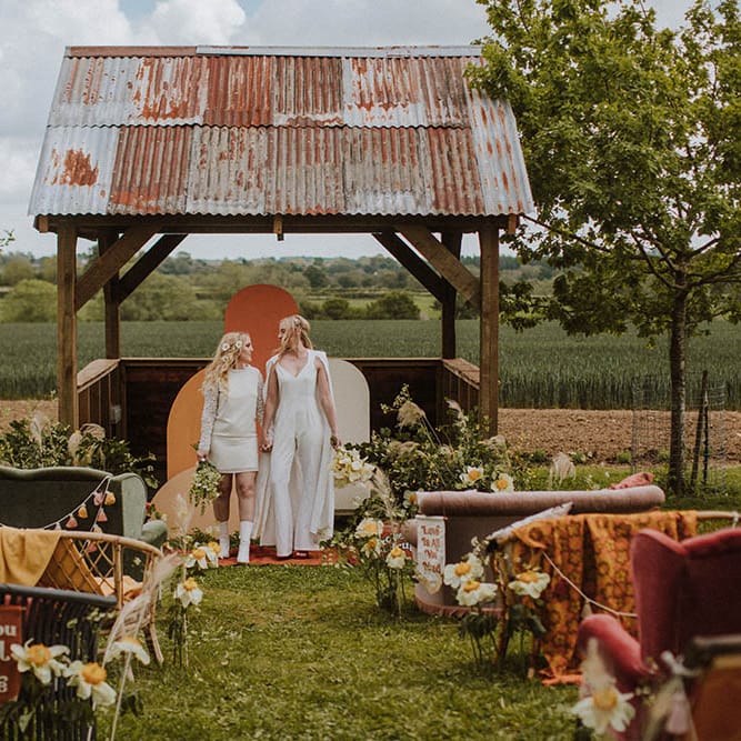 Outdoor wedding at Huntsmill Farm in Buckinghamshire with sixties wedding decor including bold colours, quirky details and wildflowers