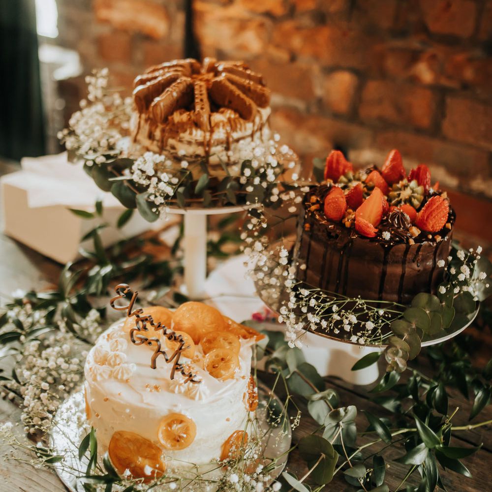 Three single tier wedding cakes with foliage decor and gypsophilia for industrial rustic wedding