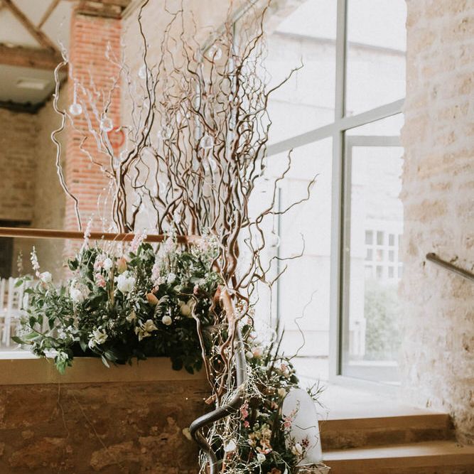 Floral arrangement display with foliage, neutral toned flowers and twigs at Hooton Pagnell Hall