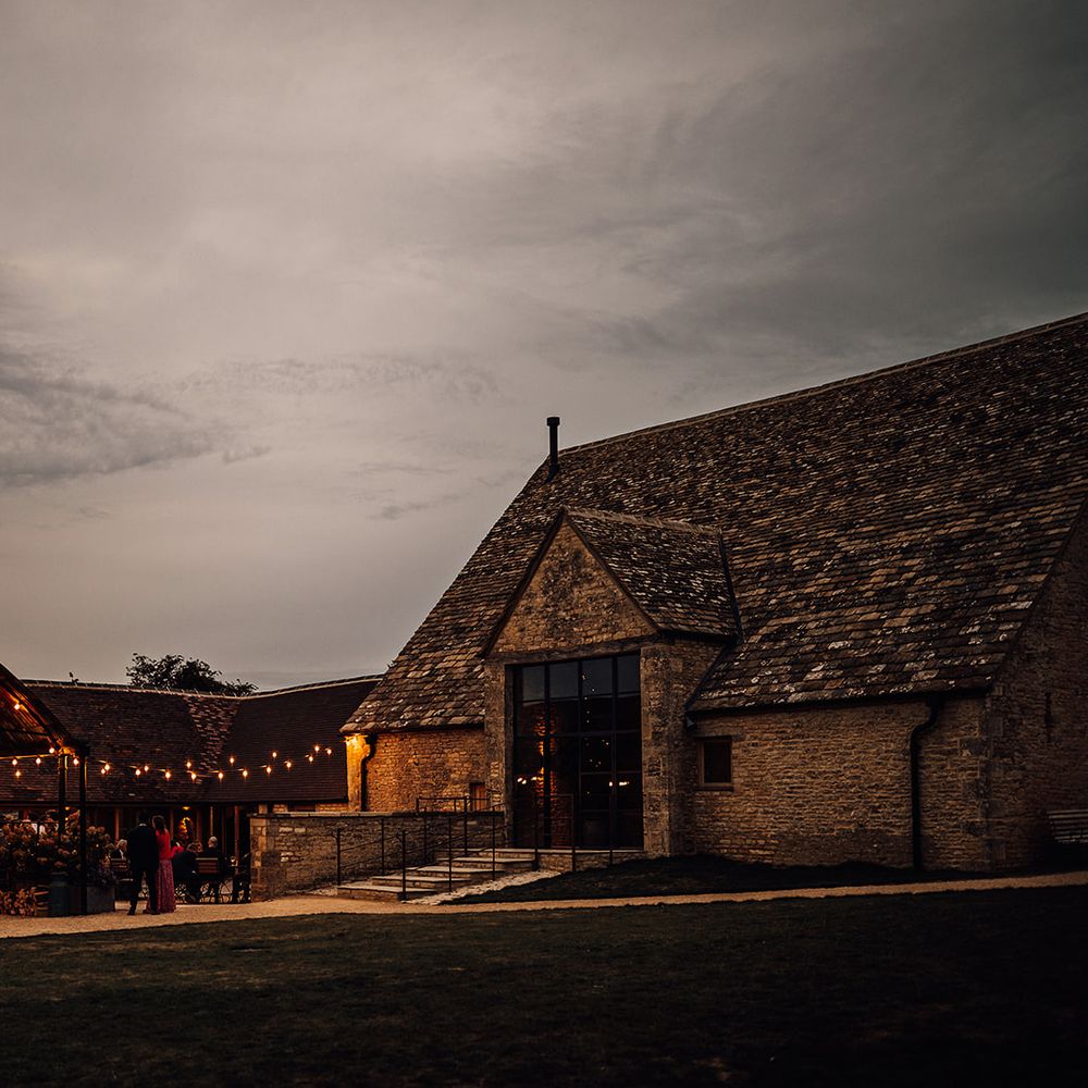 Old Gore Barn wedding venue lit up for the evening 