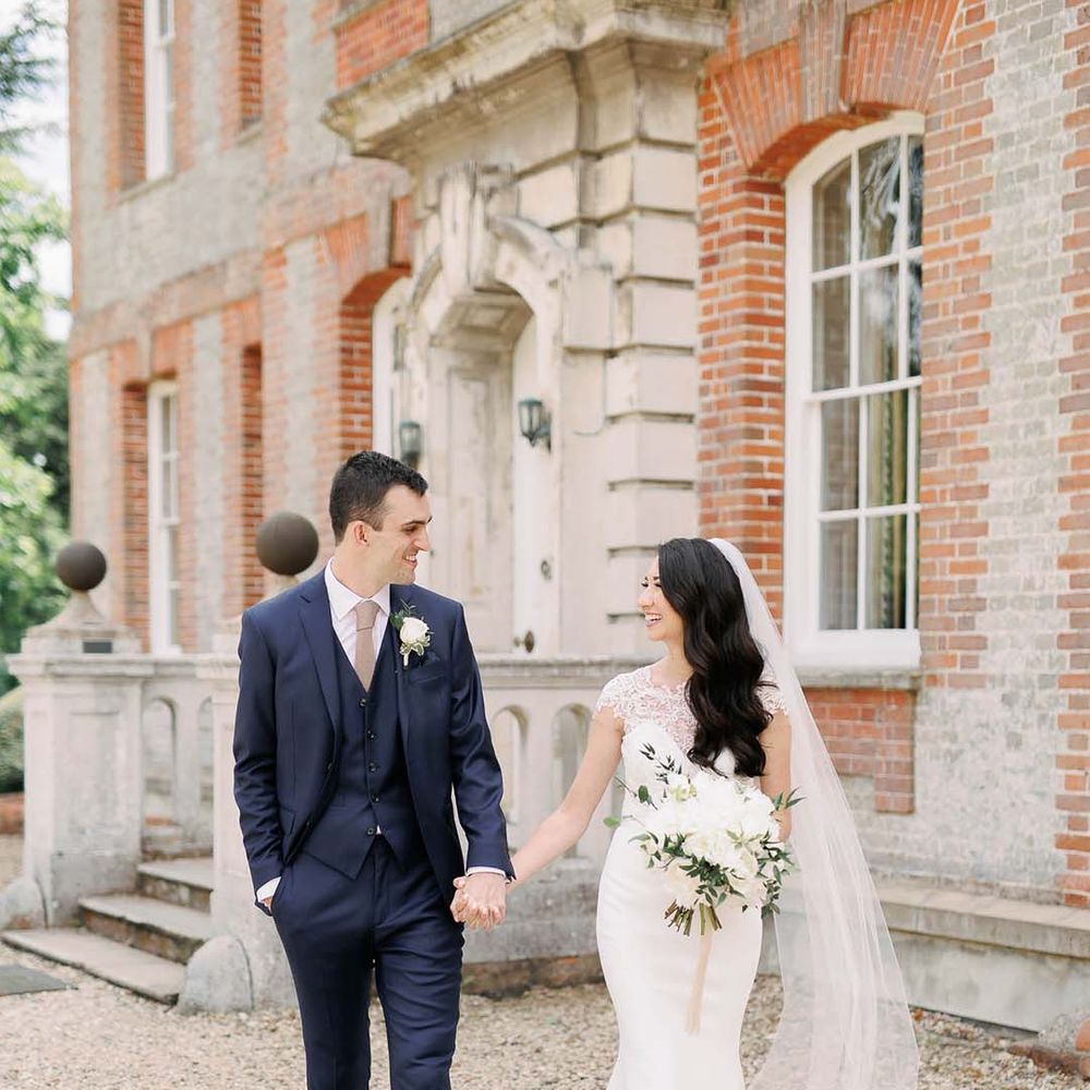 Classic Ardington House wedding with bride in a fitted wedding dress and groom a navy blue suit 