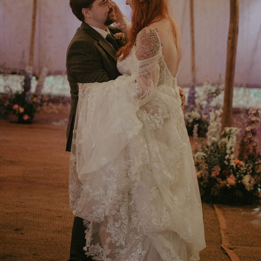 Groom in tweed suit with the bride in boho floral lace off the shoulder wedding dress 