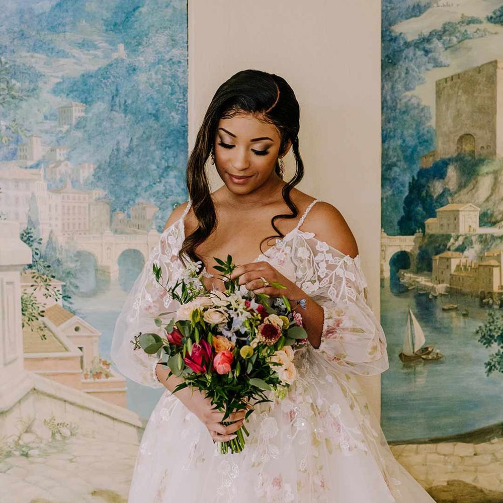 Bride in v-neck long sleeve shoulder cut out 3d appliqué wedding dress with flecks of gold holding large dried flower, eucalyptus, spring florals and garden rose bridal bouquet 