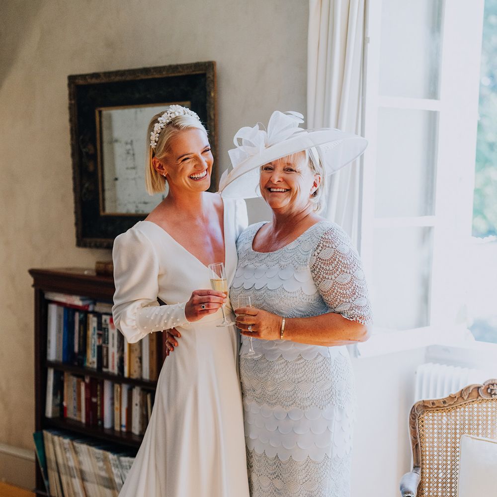 blue lace mother of the bride dress and wide brim hat 