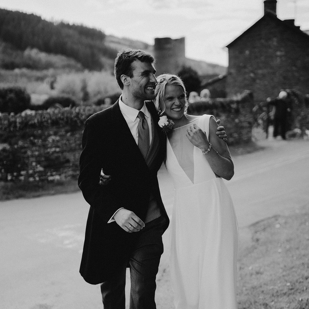 Groom in traditional morning suit for traditional wedding with the bride in classic Andrea Hawke wedding dress 