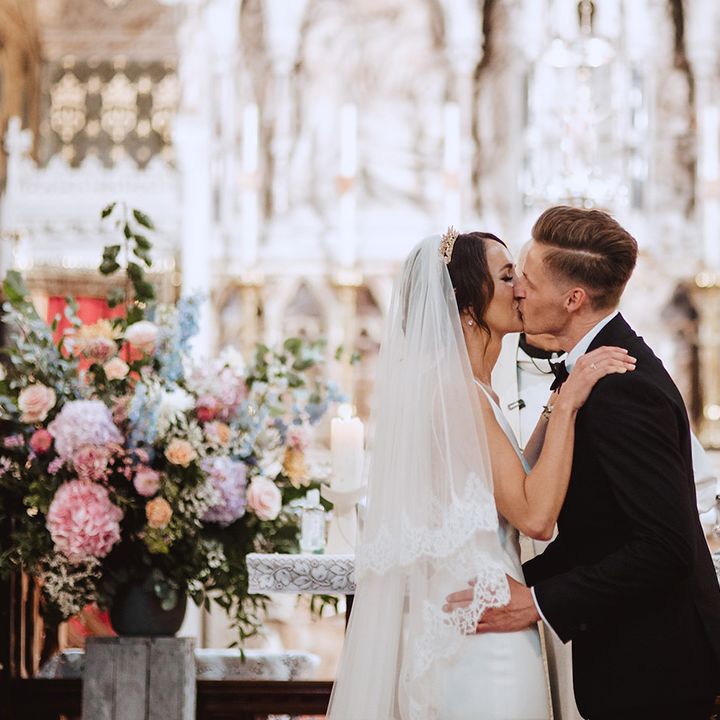 Bride wearing cathedral length veil for Catholic church wedding ceremony 