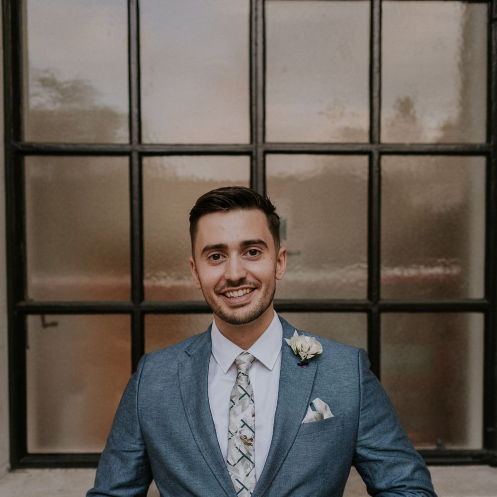 Groom in grey suit at micro wedding 