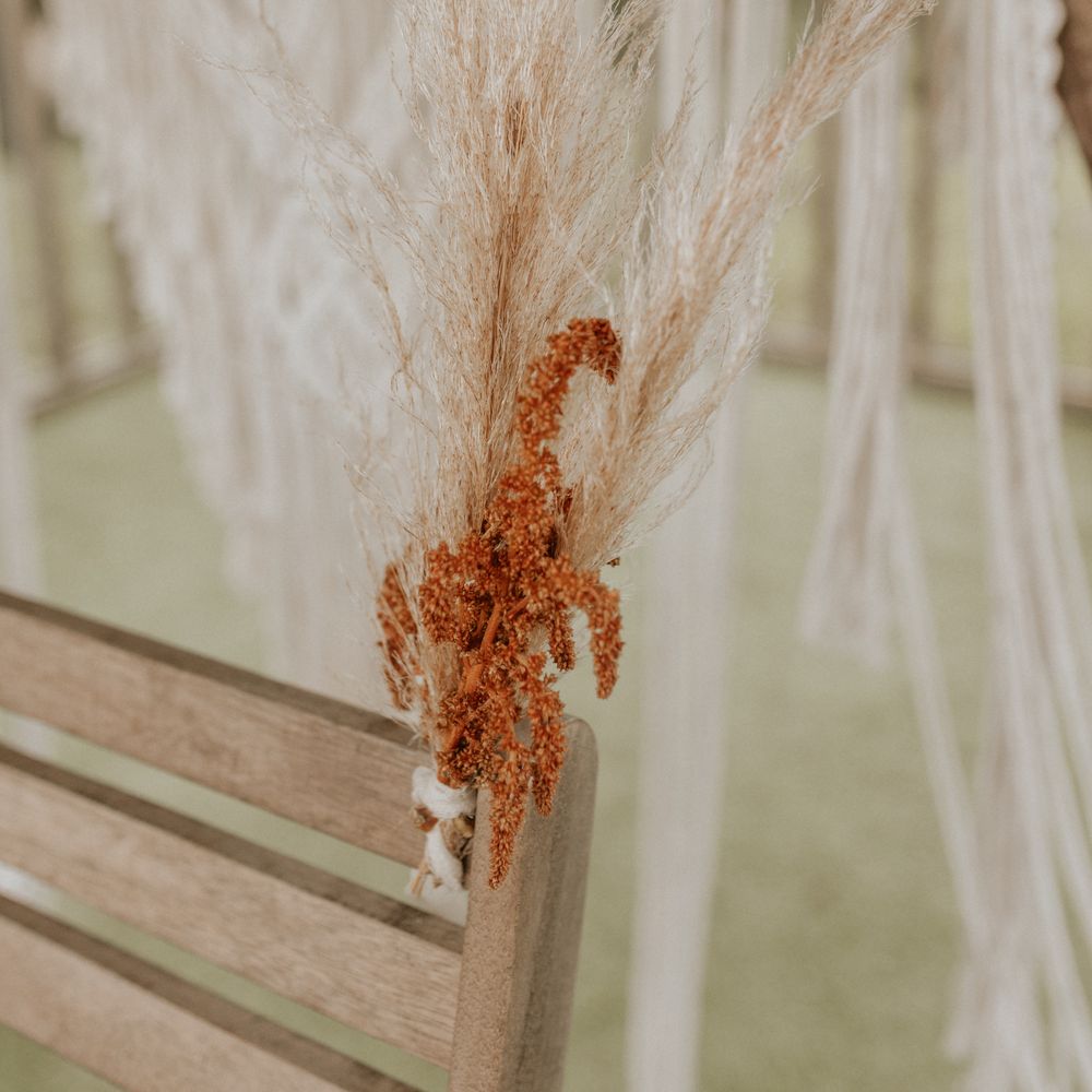 Boho floral decoration tied to wooden chair