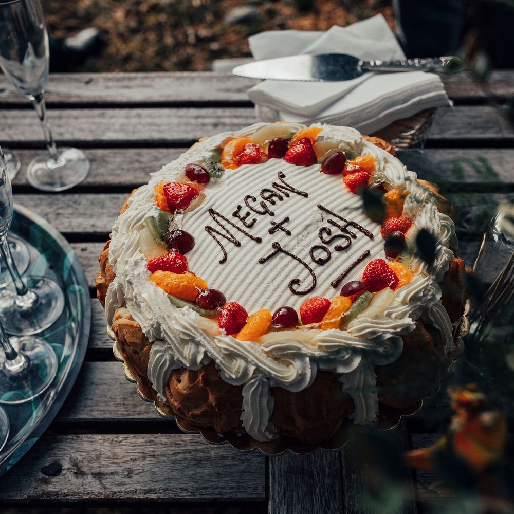 Wedding cake with Megan & Josh written on top in icing
