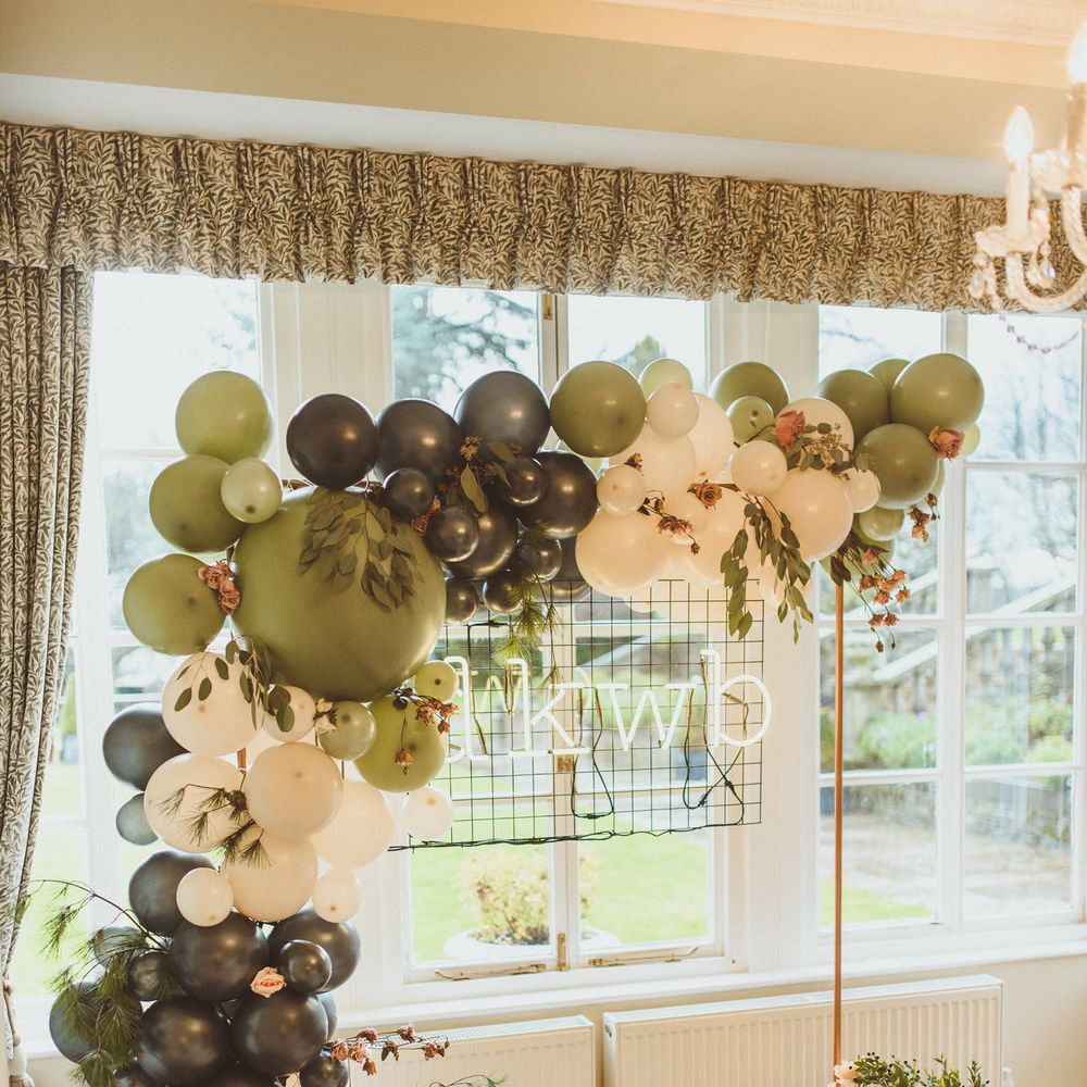 Green and white balloon arch wedding decor