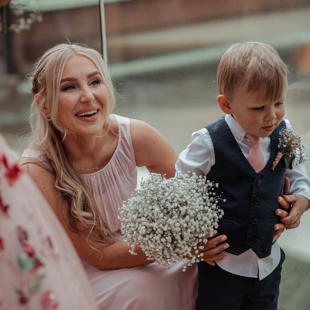 Bridesmaid stands with little boy