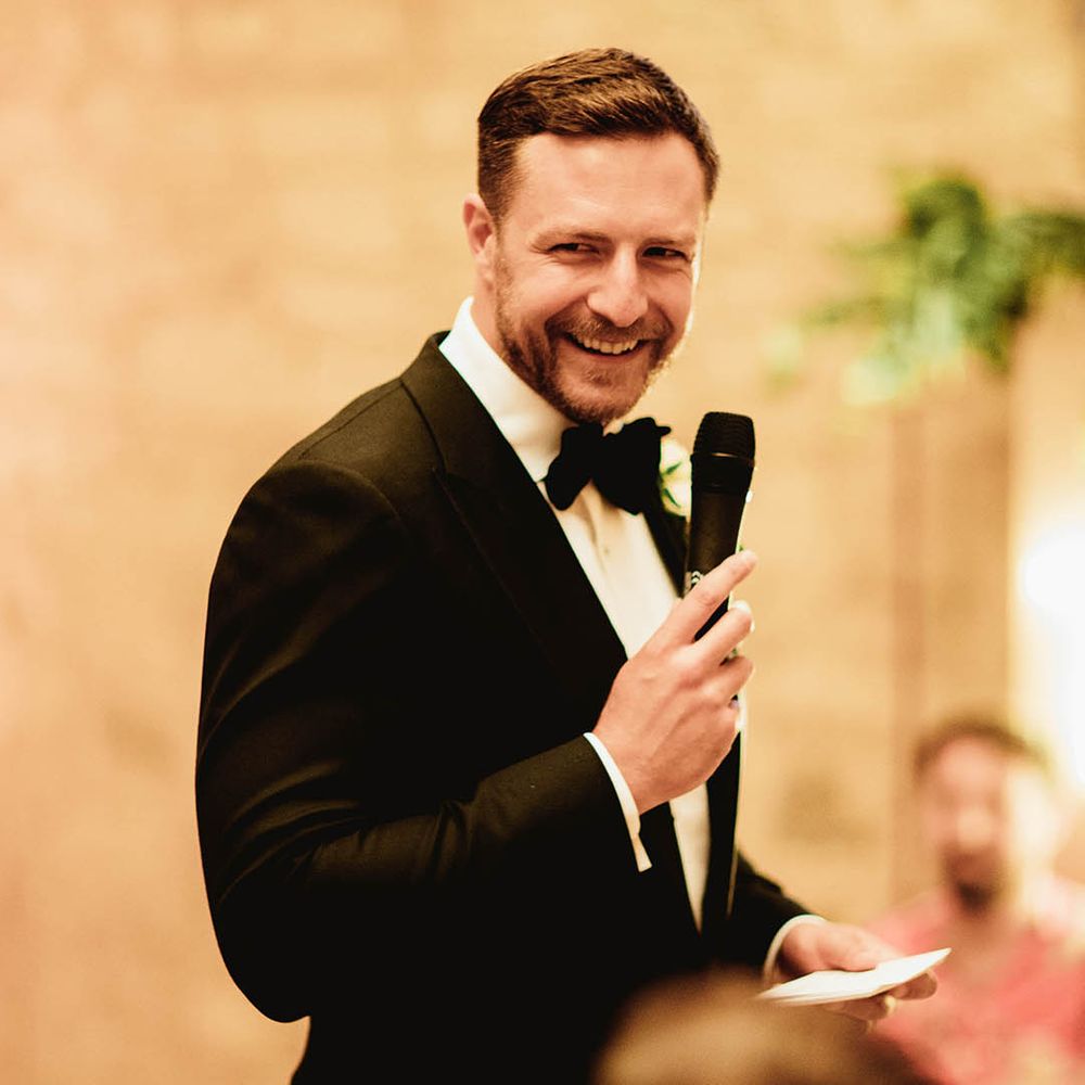 Groom gives speech on his wedding day whilst wearing black tie