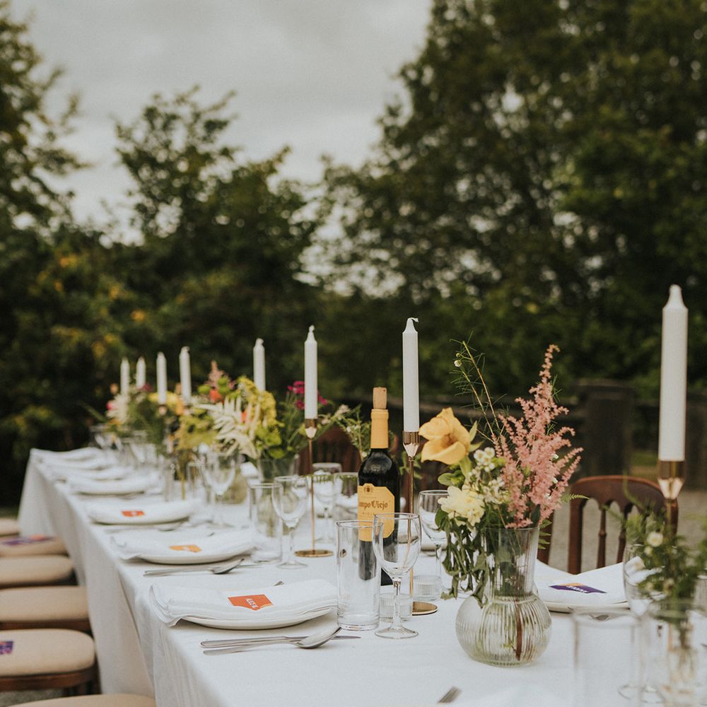 Outdoor wedding reception at Colehayes Park with taper candles and flowers in vases 