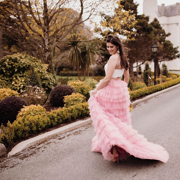 Bride in a pink ruffled wedding skirt and white top bridal separates at Ballykealey House wedding venue in Ireland 
