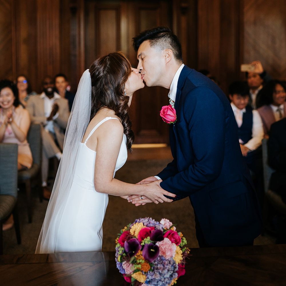 Bride & groom kiss at the Old Marylebone Town Hall during wedding ceremony 