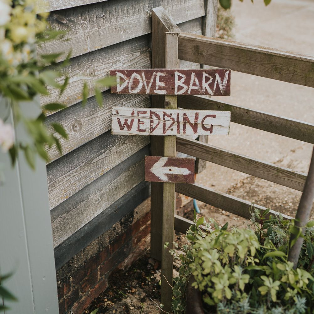 Dove Barn Weddings venue with handpainted signage directing the guests 