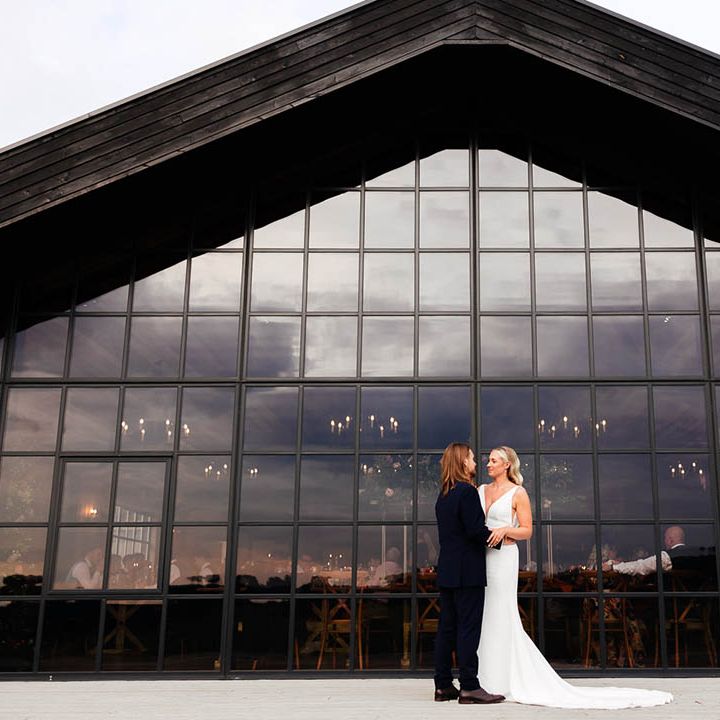 Botley Hill Barn wedding venue with incredible windows featuring the bride and groom 