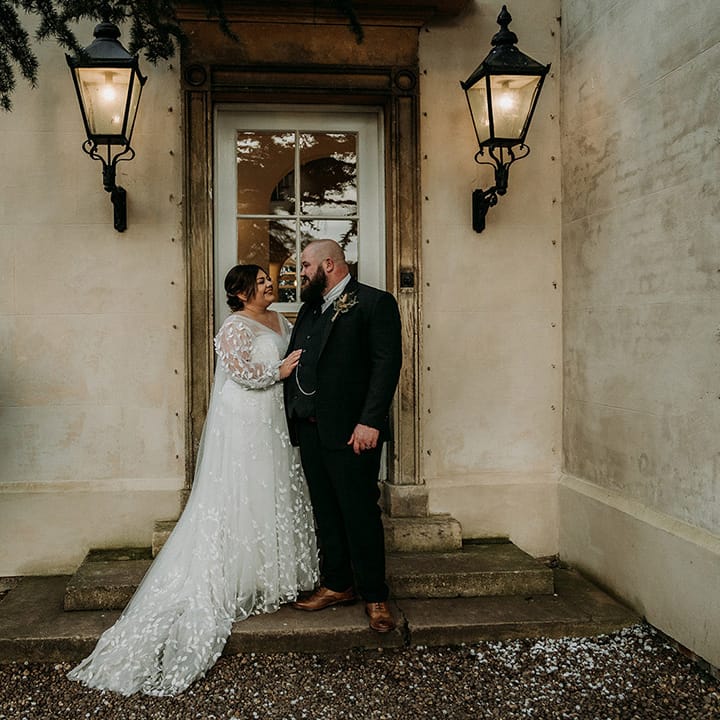 Groom in green tweed wedding suit with the bride in lace wedding gown at Aswarby Rectory in Lincolnshire 