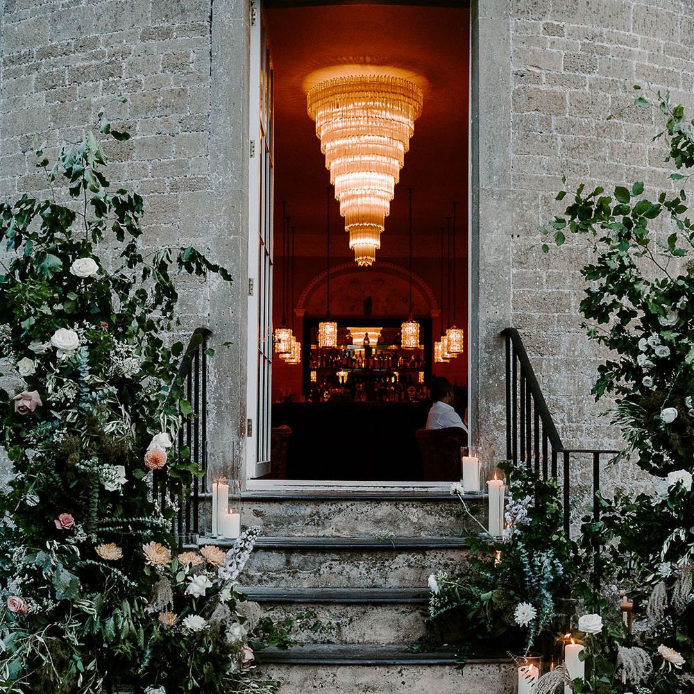 Babington House wedding venue decorated with white flower columns 