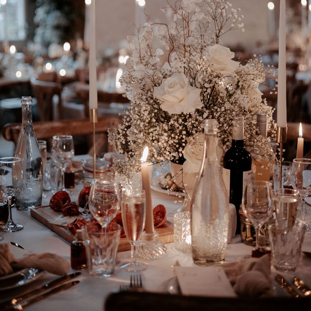 The wedding tables are decorated with white wedding flowers and white table name signage at winter wedding venue 