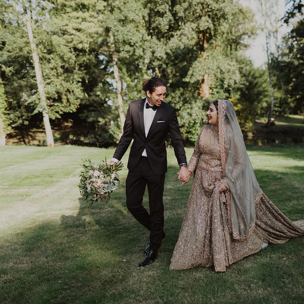 Portrait of the groom in tuxedo and the bride in a gold dress 
