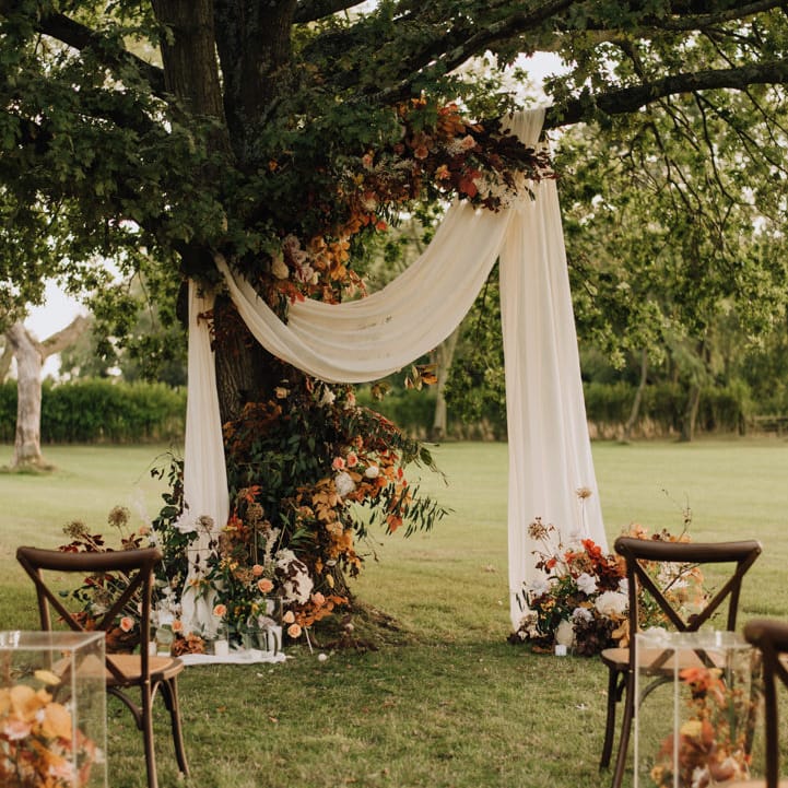 Natural, rustic outdoor ceremony at Reymerston Hall