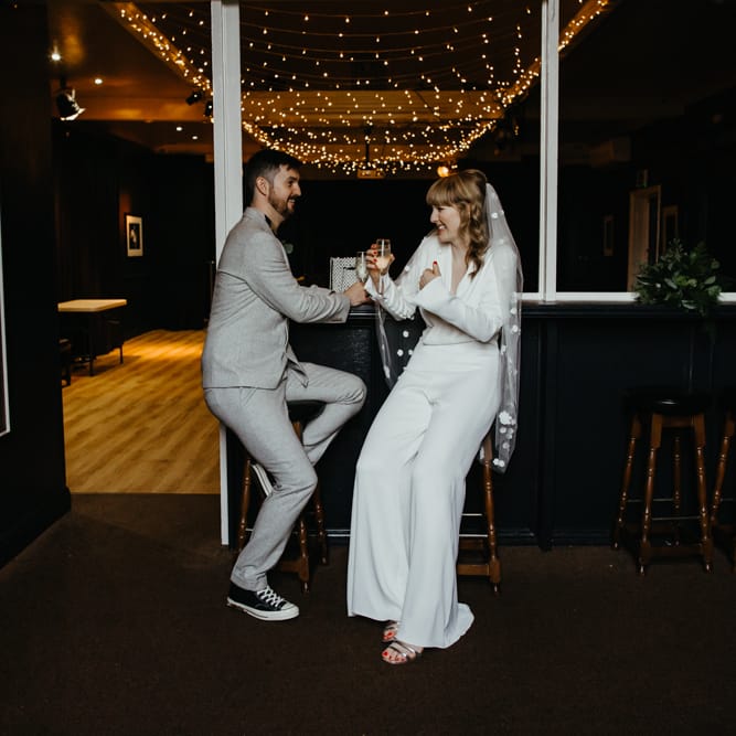 Bride and groom enjoying a drink together before the wedding ceremony to calm their nerves 