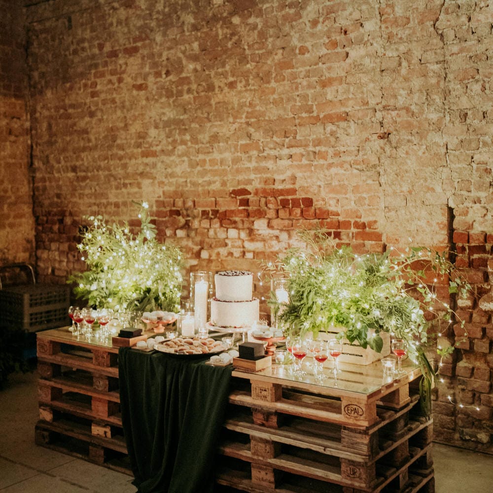 DIY rustic wedding table decor made out of wooden pallets and fairy lights