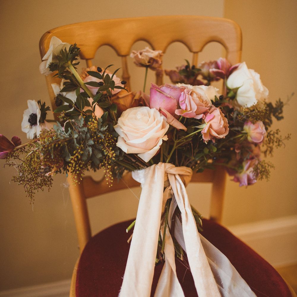 Romantic blush pink and foliage wedding bouquet tied with ribbon 