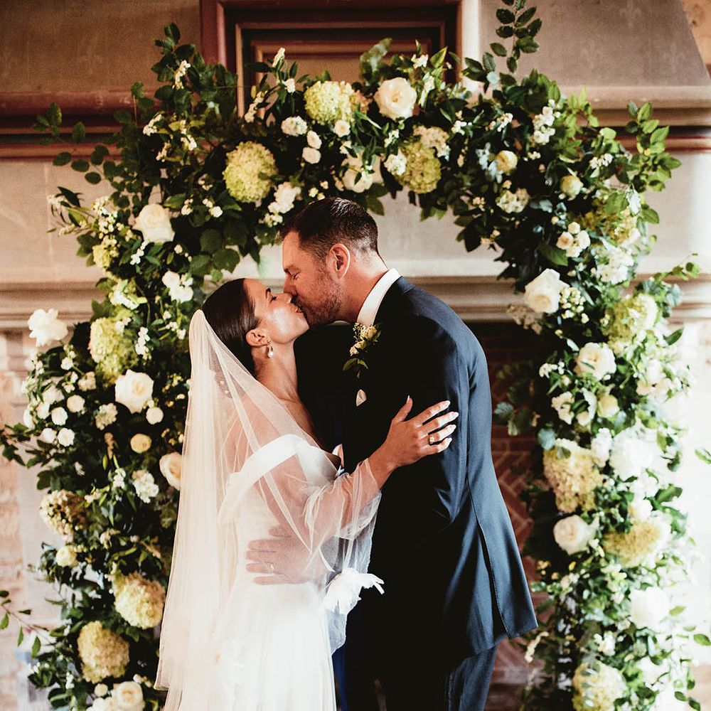 Bride & groom kiss during wedding ceremony