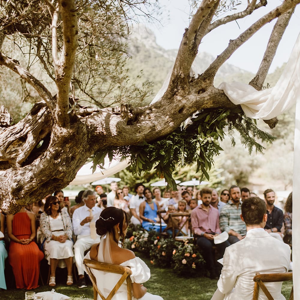 bride and groom seated at the end of the aisle