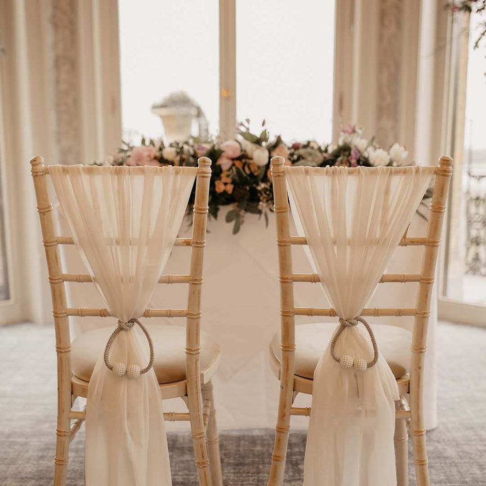 Two chairs with white fabric detailing at wedding at the Petersham Hotel in Richmond